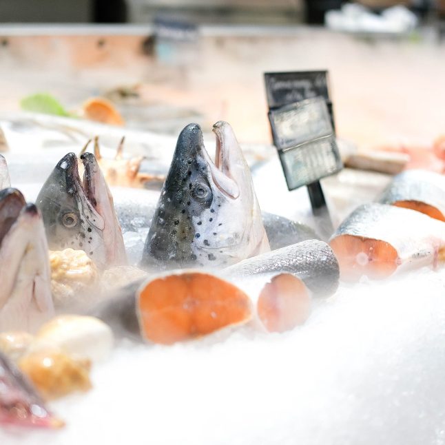 Refrigerated showcase with salmon in the store. Chilled red fish is sold in the supermarket.